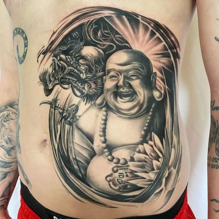 Laughing Buddha tattoo at stomach